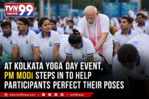 Prime Minister Narendra Modi assists participants with their yoga postures during the International Yoga Day event in Kolkata as thousands gather for the nationwide wellness celebration. TVN99 News graphic highlights the moment.